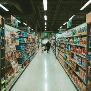 a person walking down a aisle in a grocery store