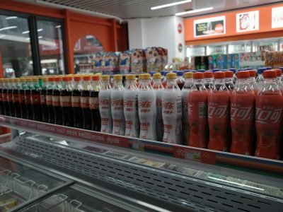 Bottles of drinks are neatly arranged in a store.
